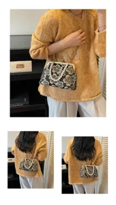 Vintage floral embroidered kiss-lock handbag with pearl handle and chain strap for women.