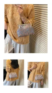 Detail view of a vintage Chinese style panda and bamboo print kiss-lock shoulder bag.