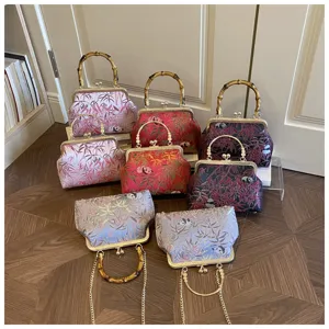 Traditional Chinese style kiss lock handbag with bamboo handle, vintage brocade fabric bag.