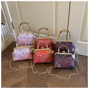 Chinese style retro kiss lock shoulder bag with bamboo handle and cute panda pattern for women.