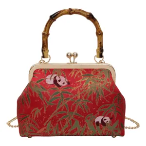 Detailed view of the vintage Chinese style red panda bamboo pattern kiss-lock handbag.