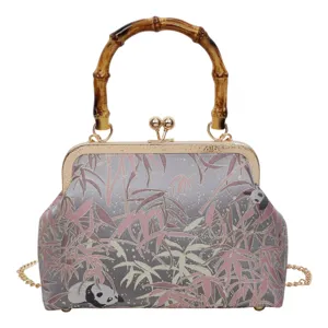 Exquisite Chinese style vintage kiss-lock handbag featuring bamboo handle and panda pattern details.