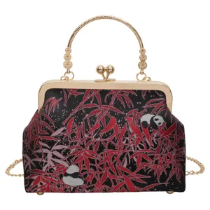 Details of Chinese vintage kiss-lock bag featuring intricate red bamboo and panda woven fabric.