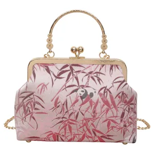 Close-up detail of the vintage Chinese style kiss-lock bag featuring pink bamboo and panda pattern fabric.
