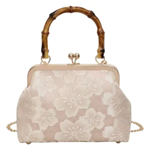 Retro embroidered cherry blossom handbag with bamboo handle and gold chain. Elegant evening bag for women.