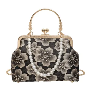 Exquisite vintage evening handbag detail, black floral embroidered lace, elegant pearl strap.