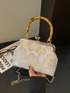 Vintage floral kiss-lock handbag with bamboo handle and chain strap for evening and retro party.
