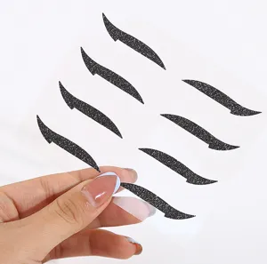 Close up detail view of black glitter self adhesive eyeliner stickers for stage party.
