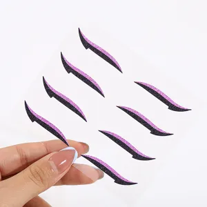Glitter eyeliner stickers detail view, self-adhesive curved black and purple makeup accessory for party.