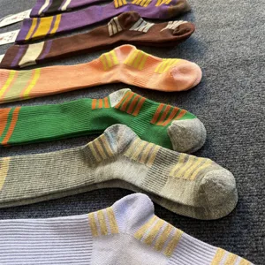 Merino wool striped knee high socks detail shot, retro college style long tube socks for women.