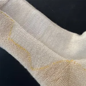Close-up detail of thermal merino wool mid-tube socks, thick terry loop knit texture.