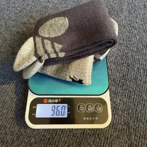 Merino wool striped long socks shown on weighing scale, cozy winter warm knee high socks main view