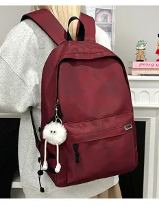 Detailed view of the stylish tie-dye casual backpack with a cute plush charm for daily use.