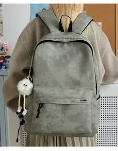 Tie dye large capacity backpack for school and daily commute with furry pendant detail.