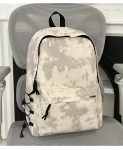 Detailed view of the stylish tie-dye backpack showcasing front pocket and side cord design.