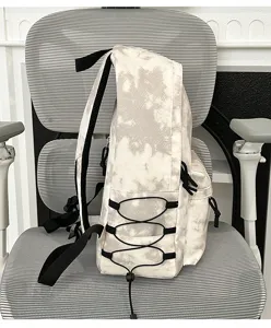 Side view detail of stylish tie-dye canvas backpack for school, travel, and casual commute.
