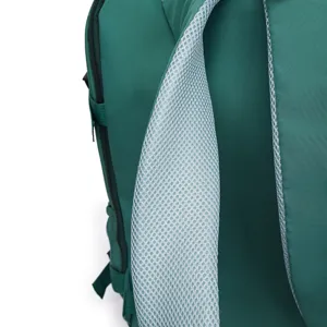 Detail view of breathable mesh shoulder strap on casual green travel backpack, close-up.