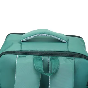 Closeup of green backpack top handle and dual straps detail, durable daily school bookbag design.