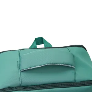 Green backpack top handle detail shot, showing zipper and durable fabric design texture.