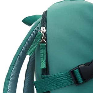 Close-up detail of green backpack zipper, mesh straps, and side buckle for casual travel.