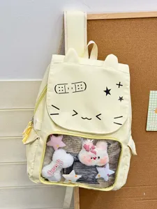 Vista dettagliata dello zaino giallo con finestra trasparente, viso di gatto e peluche.
