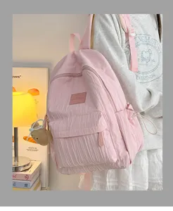 Pink casual backpack for women, lightweight school bag with multi pockets and cute pendant.