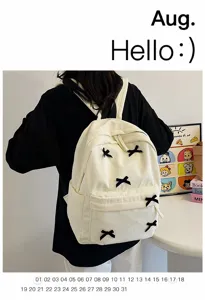 Japanese style corduroy backpack for women, cute white school bag with black bows and pockets.