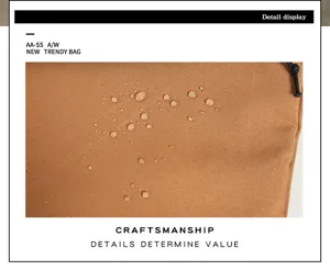 Detailed view of the brown waterproof backpack fabric showing water-resistant performance.