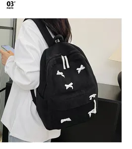 Japanese ins style black corduroy backpack with cute white bows, casual school bag for stylish girls.