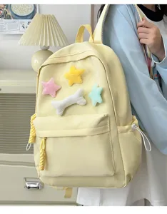 Cute yellow student backpack detail view with soft plush stars for daily school and casual use.