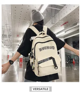 Detailed shot of a retro canvas backpack worn by a model in an indoor corridor setting.