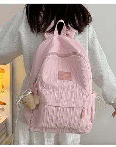 Detail view of the pink casual backpack featuring cute bear pendant and practical storage.