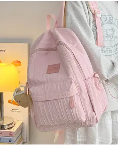 Pink pleated casual backpack for women, stylish daily school bag with cute bear pendant.