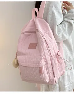 Pink casual backpack for daily use, featuring multiple compartments and clean design.