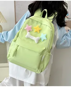 Casual light green student backpack with cute plush stars and bone decorations for daily use.
