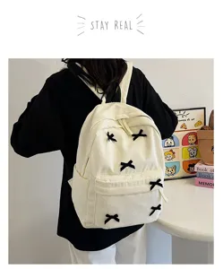 Japanese ins style white corduroy backpack for women, minimalist cute school bag with bows.