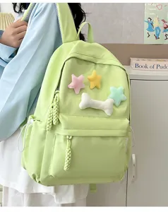 Lightweight green canvas backpack for students with cute plush star and bone charms.