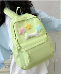 Green student casual backpack with cute plush stars and bone decoration for daily use