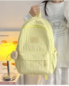 Yellow casual nylon school backpack with front pocket and plush pendant for daily use