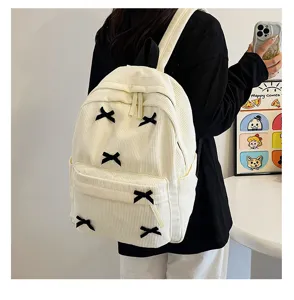 Japanese ins style corduroy backpack featuring cute black bows, perfect casual school bag for daily use.