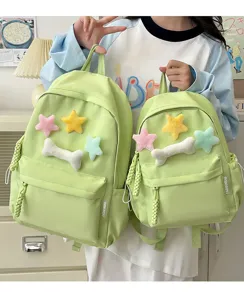 Green student backpack set with cute plush stars and bone pendant for school daily use.