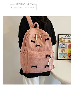 Japanese style cute pink corduroy backpack for women, trendy school bag with bow details.