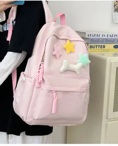 Pink student backpack with cute plush stars and bone charms, stylish casual daily bag