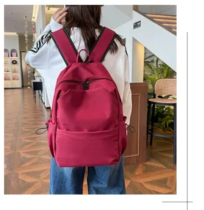 Detailed view of large capacity solid color casual school backpack in vibrant red.
