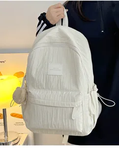 Detailed view of the lightweight solid color casual backpack with textured fabric for daily use.