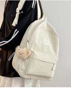 Solid color pleated backpack for women and students with cute bear plush pendant for travel.