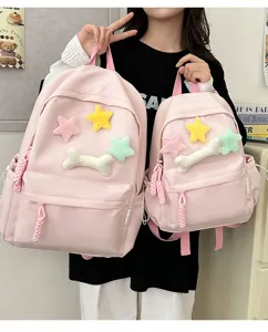 Detailed view of pink school backpack with cute plush star and bone decorations, casual style.