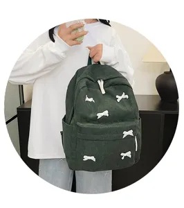 Japanese style dark green corduroy backpack for women with cute white bow knot decorations.