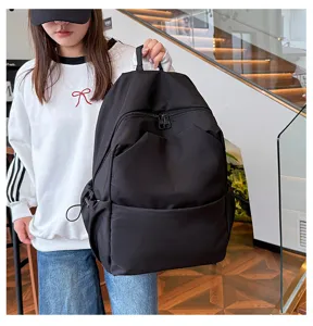 Detail shot of the solid black casual backpack showing large capacity and multi-pocket design.
