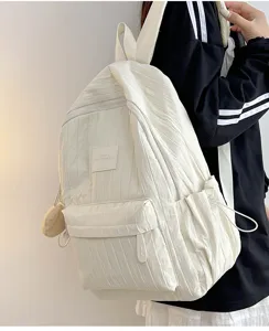 Detail view of white casual lightweight school backpack with pleated design and front pocket.